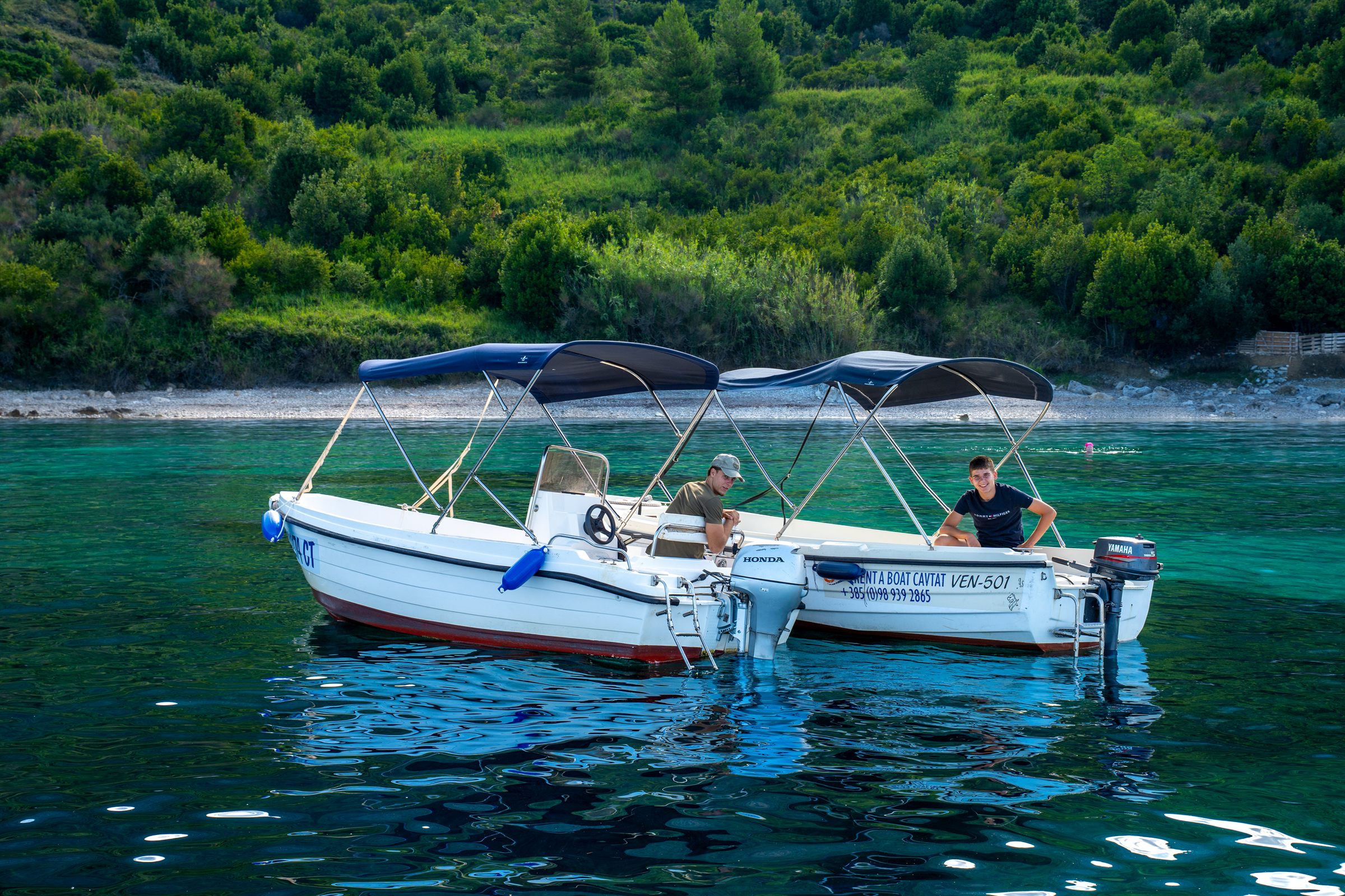 Motorboat in a turquoise Cavtat bay at golden hour
