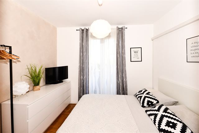 Double bedroom with TV and dresser