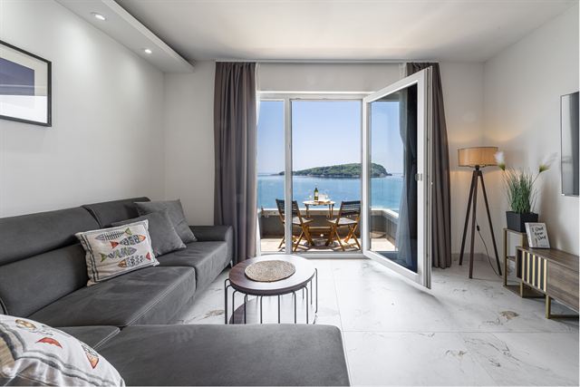 Living room with sofa and view of the islet