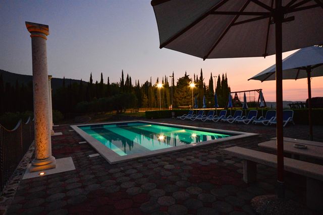 Pool and parasol at sunset