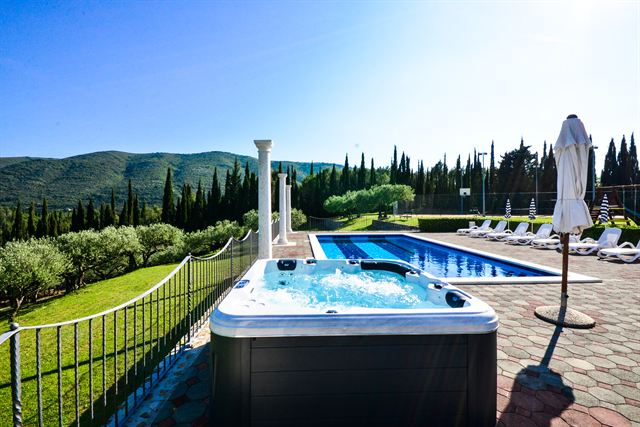 Outdoor hot tub beside the pool