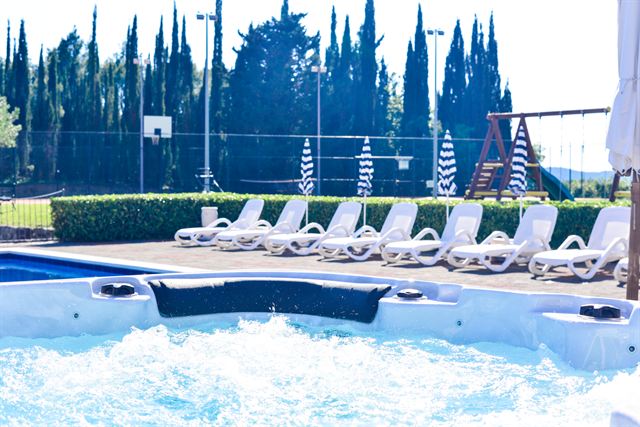 Hot tub and row of loungers by the pool
