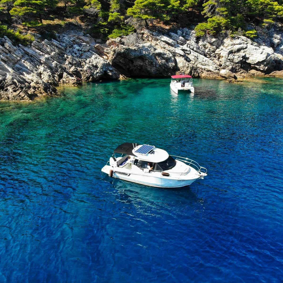 Merry Fisher 795 anchored in a turquoise Elaphite bay